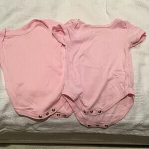 Baby pink onesies worn once. 6-9 months